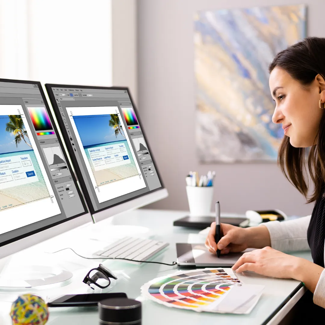 Expert businesswoman designing a website at a desk with a computer and color wheel. Captivating website design by skilled professional.