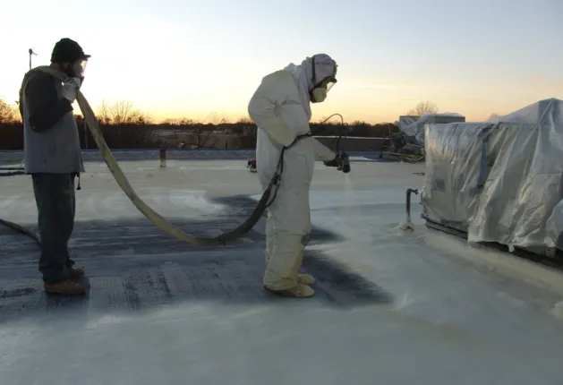 Spray foam roofing system being applied to flat commercial roof in Colorado