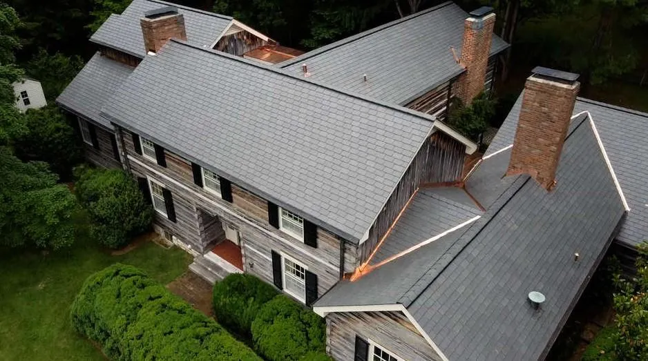 Technician replacing damaged slate tile with color-matched replacement