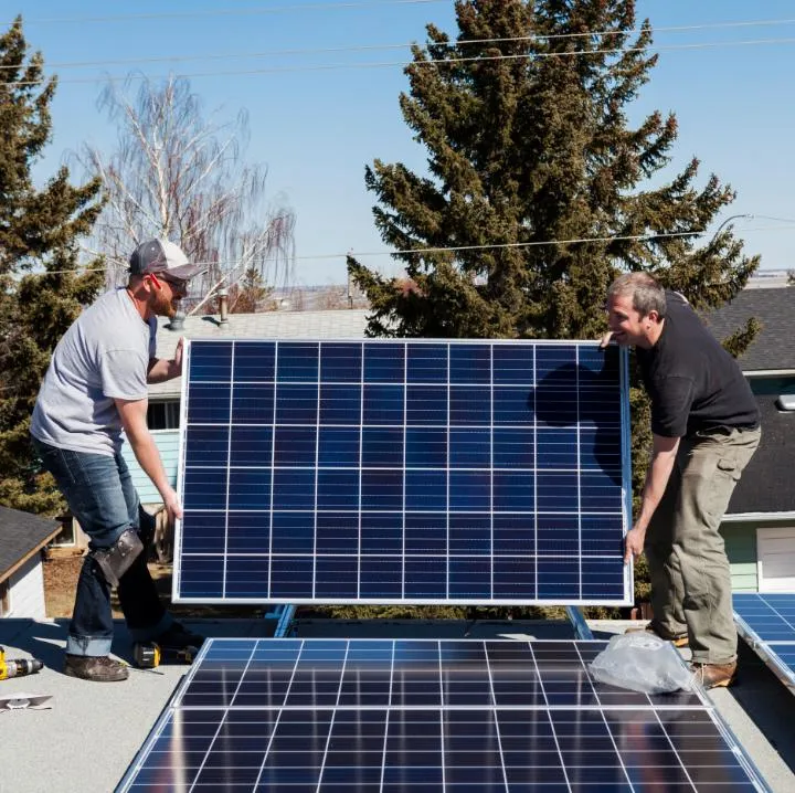 Workers installing panels