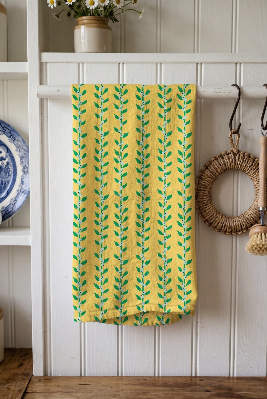 Kitchen tea towel hanging featuring the Through the Grapevine bird pattern design.