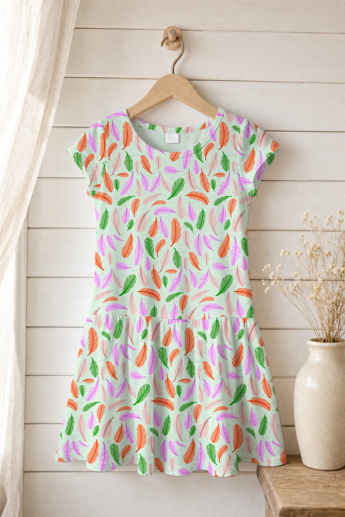 Girl's short-sleeved dress in the Feather Your Nest repeat pattern