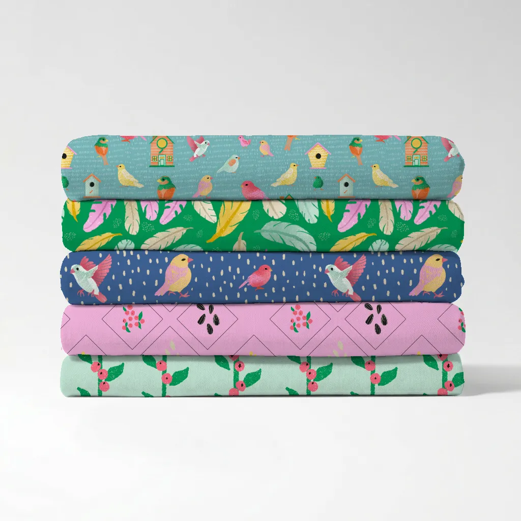 Stack of folded fabric swatches showing five repeat bird patterns from the Birds of a Feather surface pattern collection.