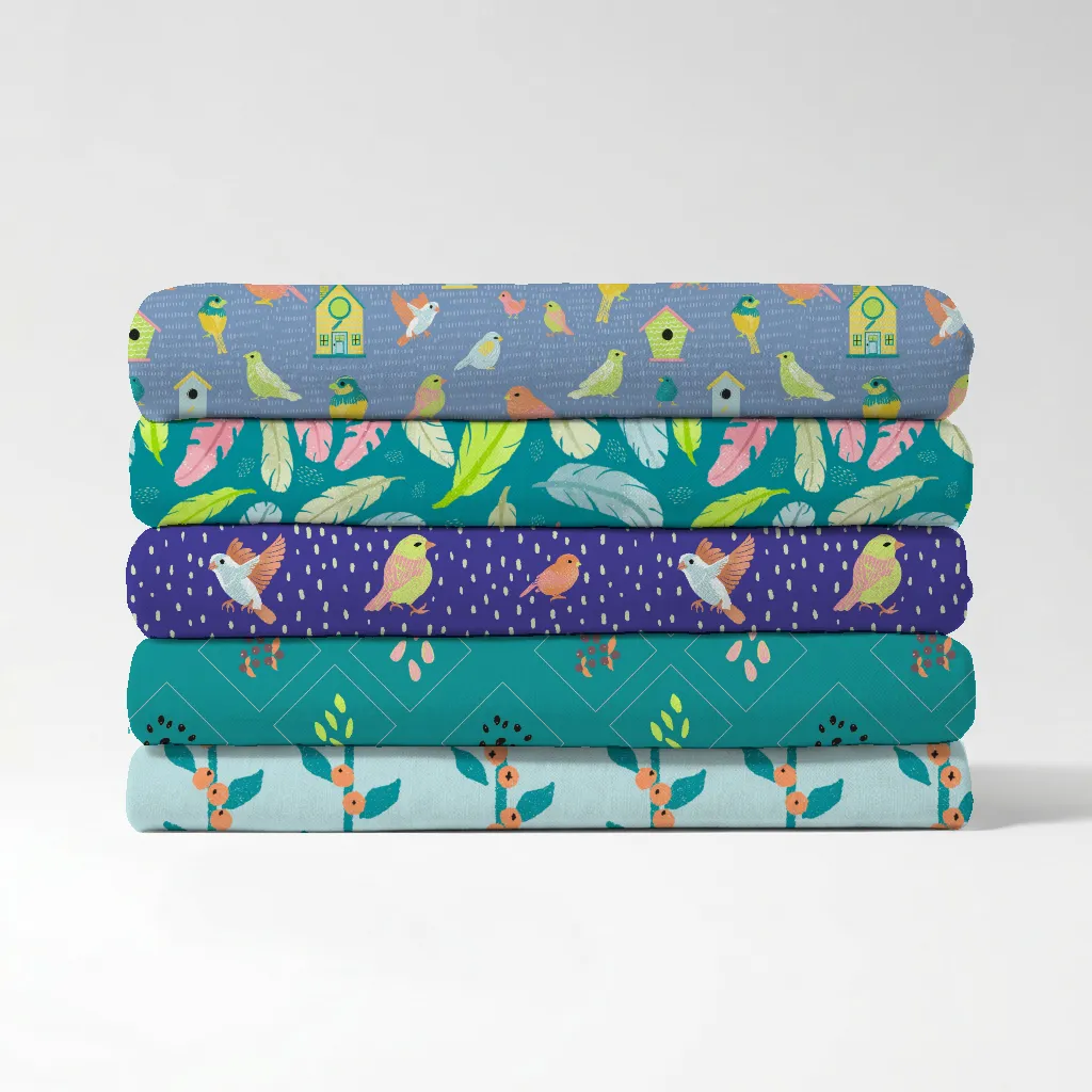 Stack of folded fabric swatches showing five repeat bird patterns from the Birds of a Feather surface pattern collection.