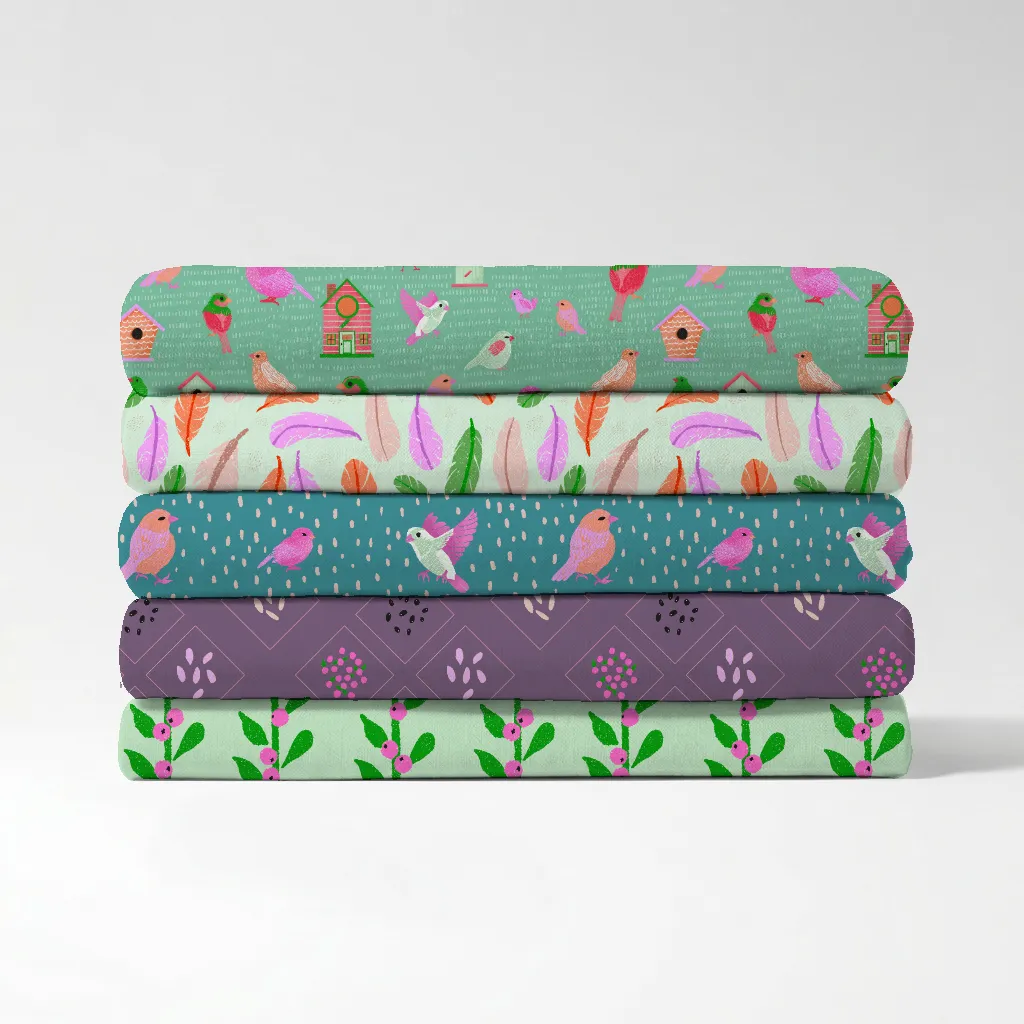 Stack of folded fabric swatches showing five repeat bird patterns from the Birds of a Feather surface pattern collection.