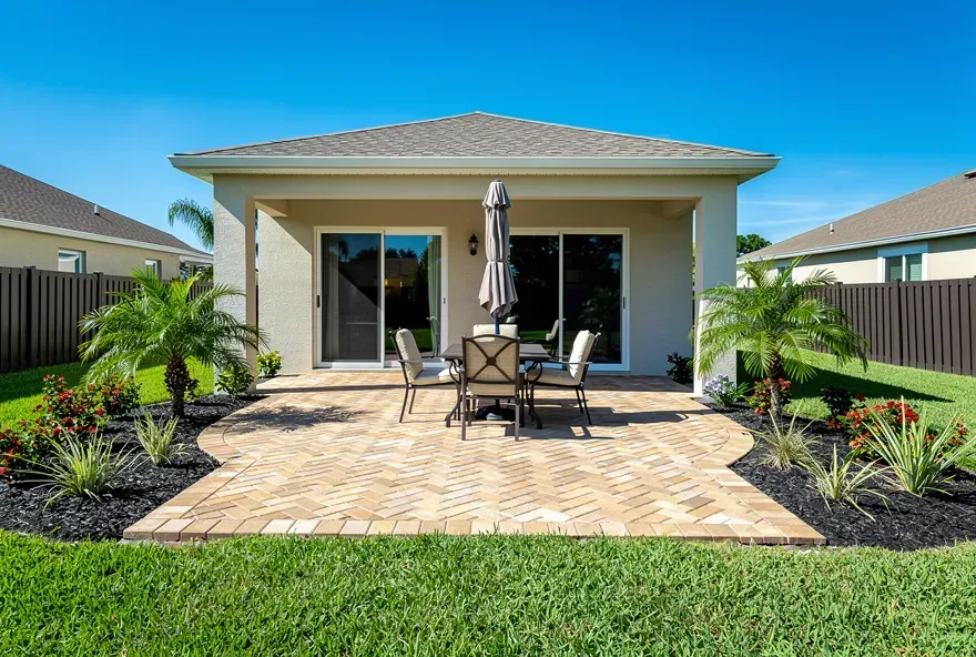 Finished paver patio attached to a home in Kendale Lakes, Florida with tan interlocking pavers
