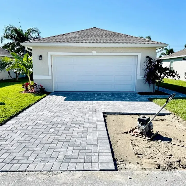 Paver driveway installation in progress attached to a garage in Kendale Lakes, Florida