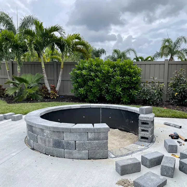 Fire pit installation in progress on a backyard patio in Kendale Lakes, Florida