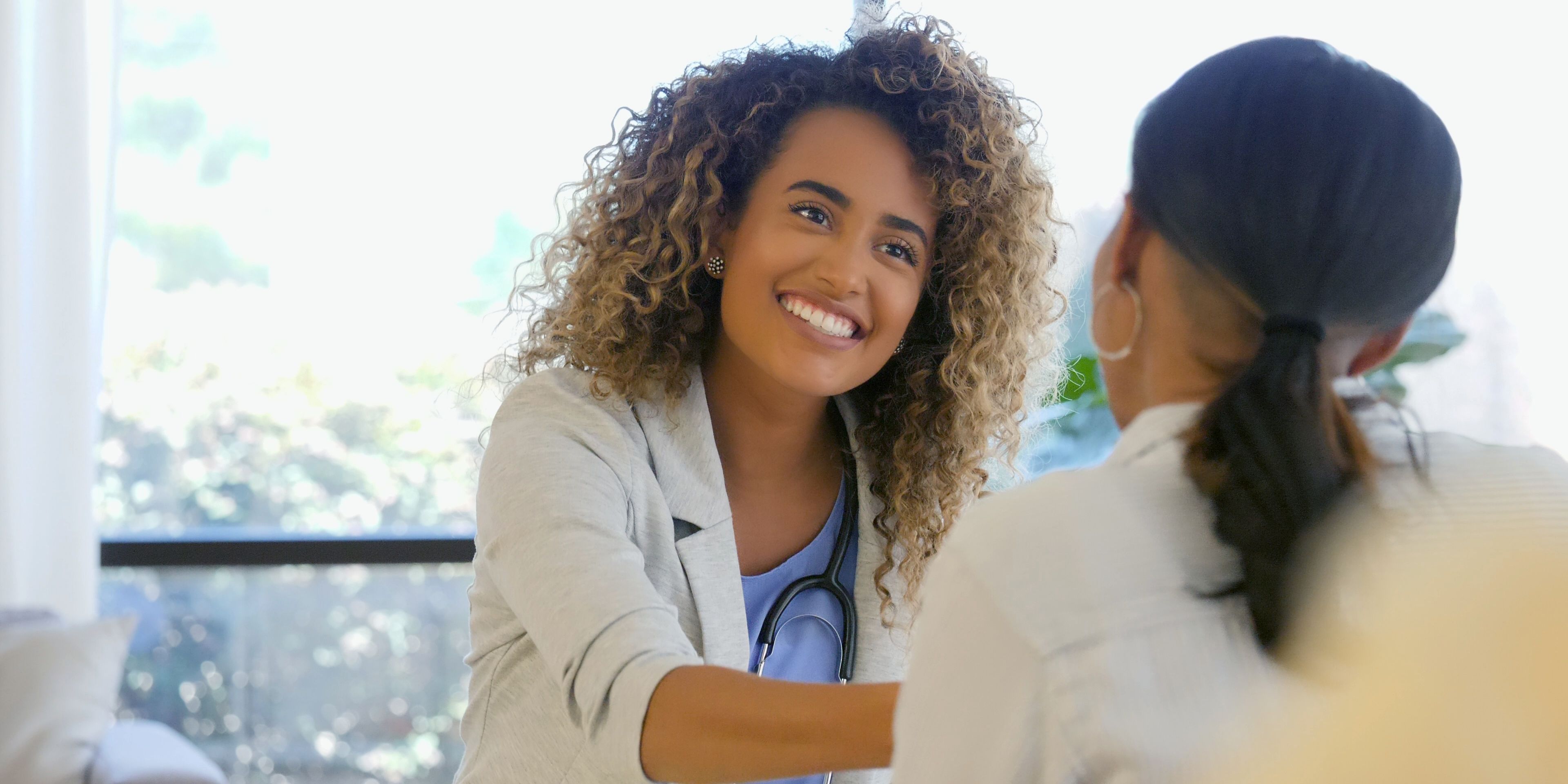 an Harper MD physician speaking with a patient about her join pain