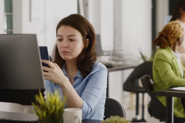 Sitting at desk on phone