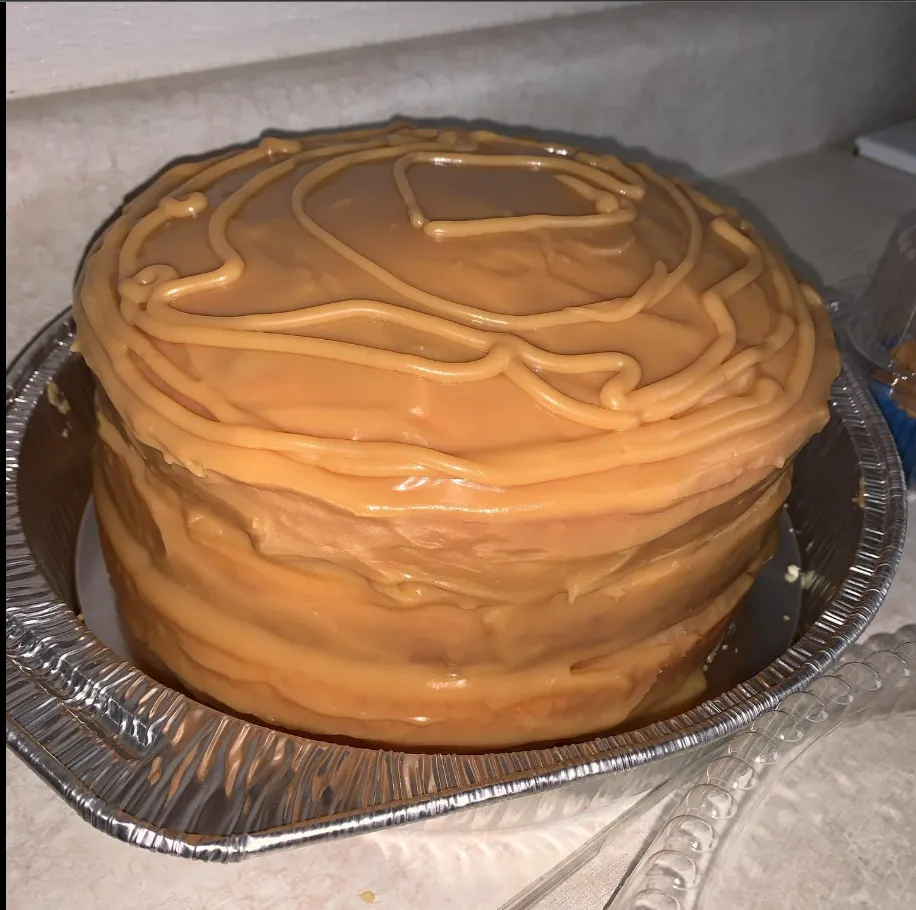 A caramel cake with a hint of sea salt, garnished with caramel shards and served on a slate board