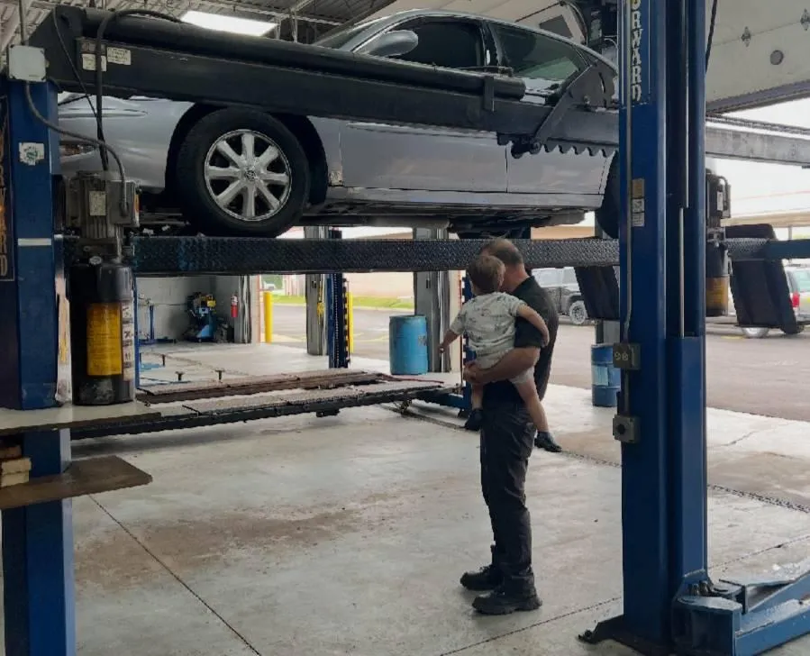A bunch of cars parked outside Mr. Auto Care for inspection.
