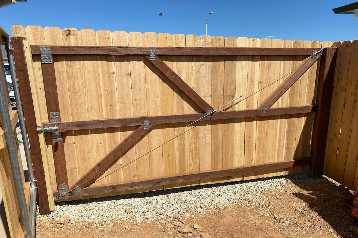 Wood fence gate construction detail showing reinforced framing and hardware for durability