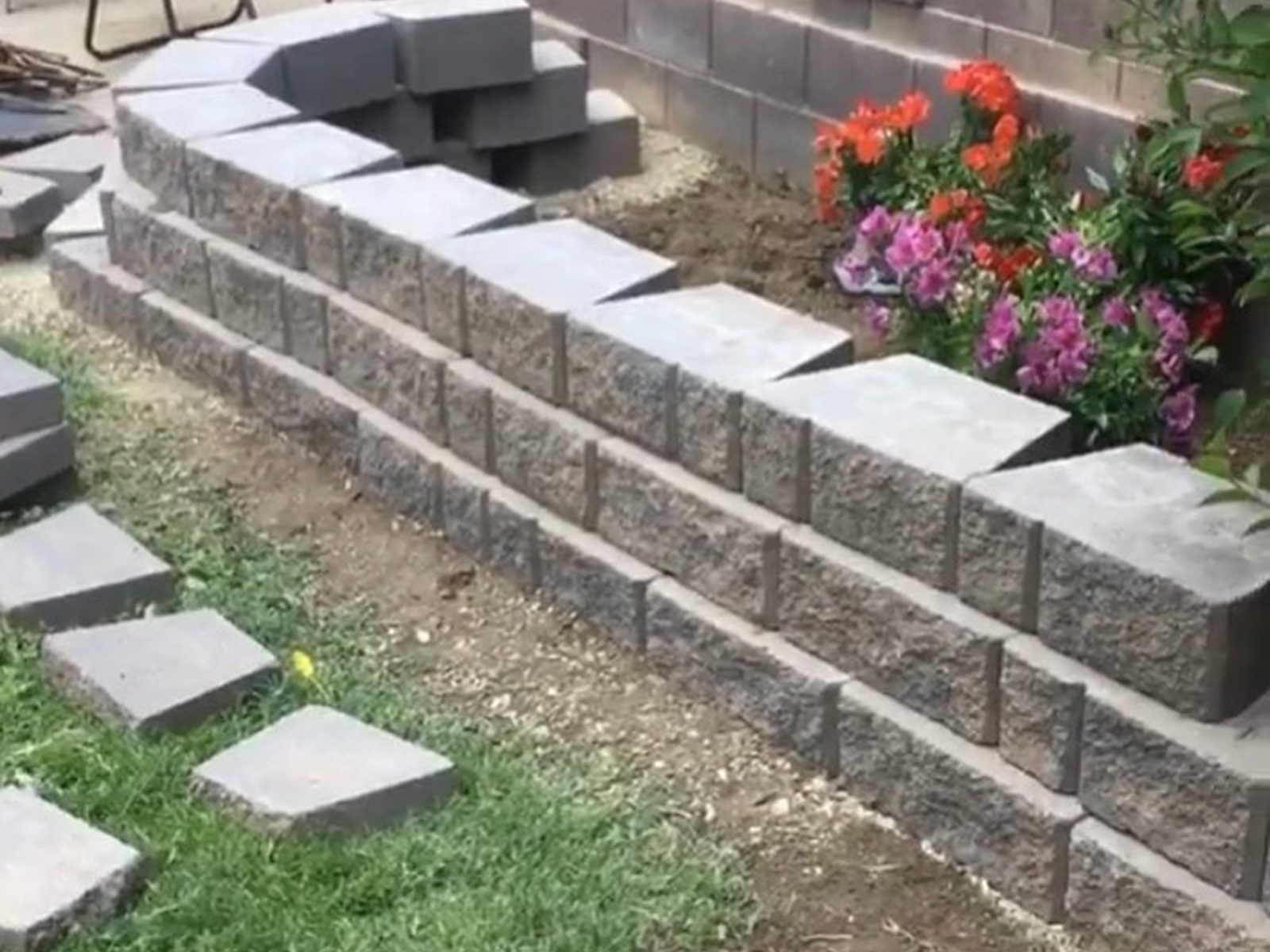 Block retaining wall installation in Redding, CA showing straight wall construction and cap block detail