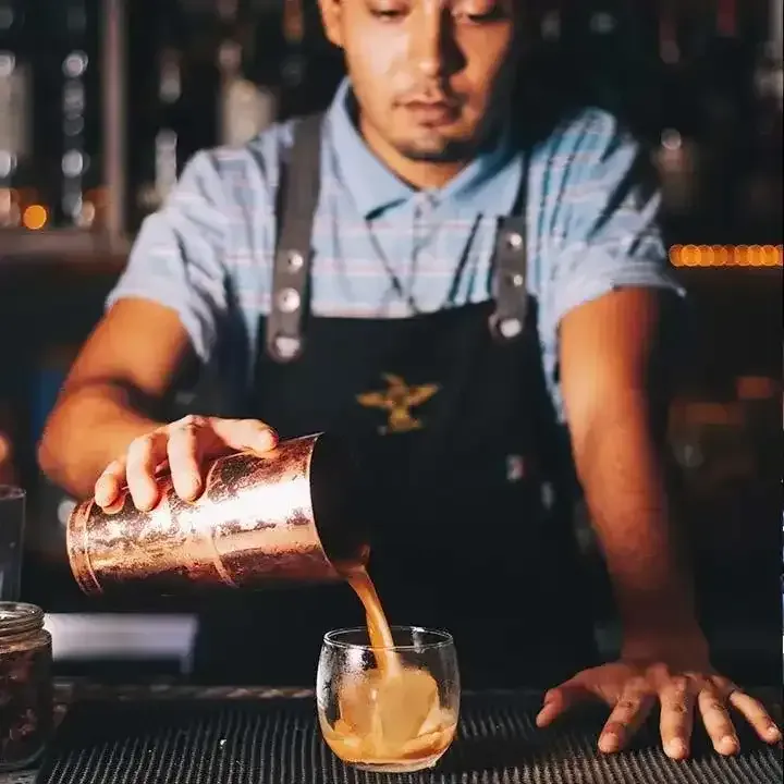 picture of our friendly bar tender pouring a cocktail