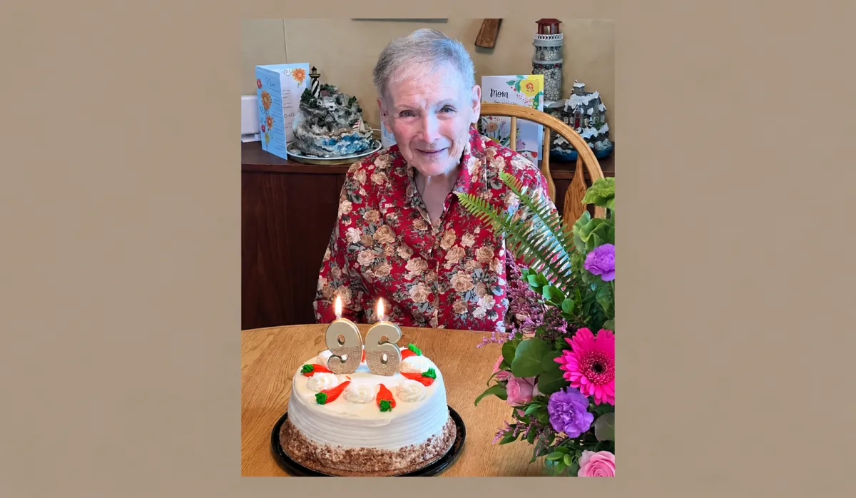 96-year-old woman celebrating her birthday with a birthday cake
