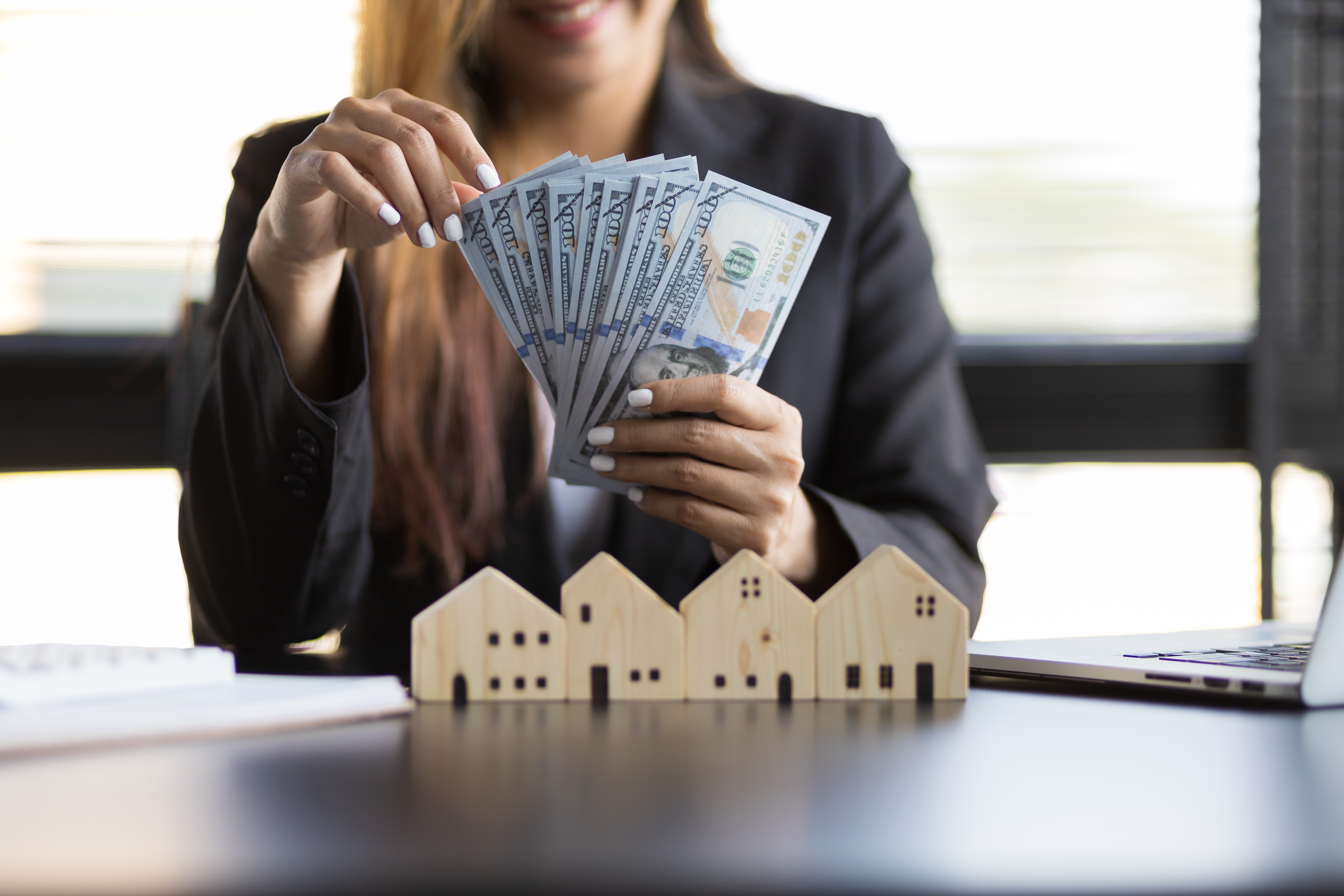 Real estate investor reviewing investment property performance, equity, cash flow, and portfolio strategy before purchasing another property.