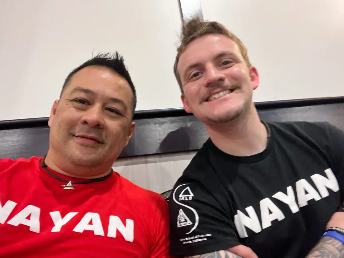 Two Inayan System of Eskrima practitioners in Inayan shirts