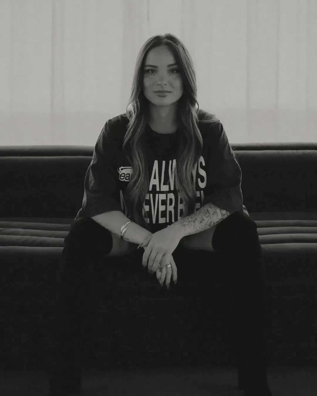 Chelsea Tansey sitting confidently while coaching a group of business leaders, demonstrating her expertise in personal brand development and leadership mentoring