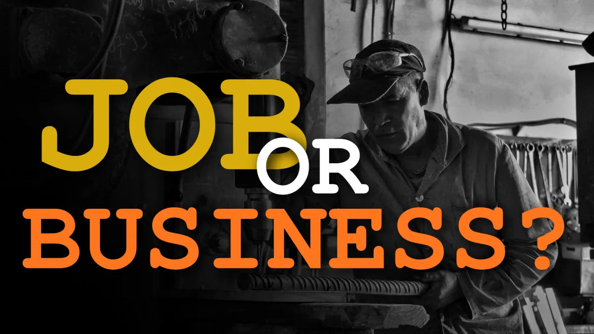 Tradesman working alone in a shop with bold text reading “Job or Business?” representing the difference between owning a business and owning a job.