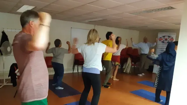 People practising Qi Gong in Peter's Qi Gong class in new malden