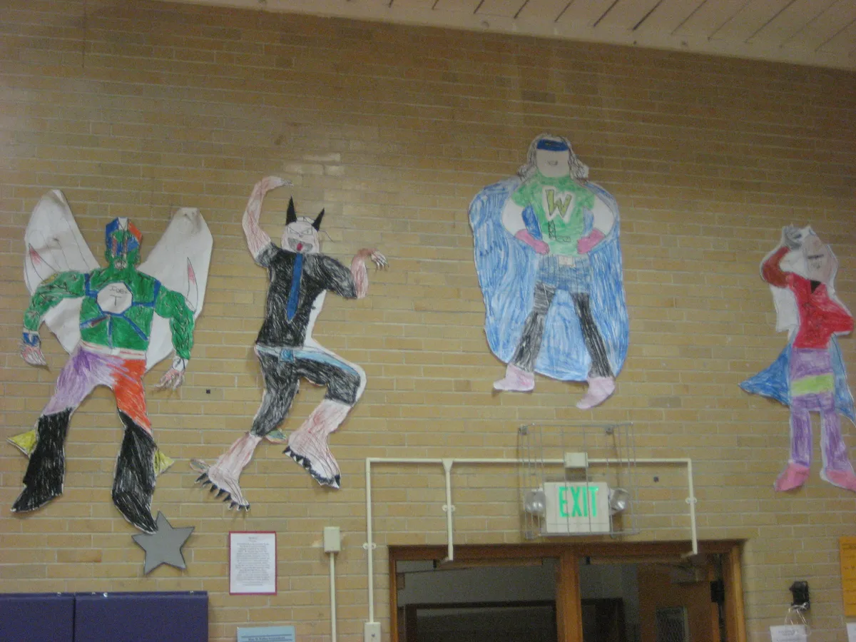 Children's hero drawings on a school wall