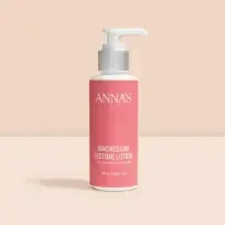 Bottle of Anna's Magnesium Bedtime Lotion set against a peachy background, showcasing its calming packaging.