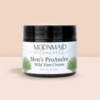 MoonMaid Men's Wild Yam Cream UK jar displayed against a peachy background, enhanced with dynamic splashes of paint for a lively effect.