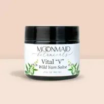 Product photo of MoonMaid Botanicals Vital “V” Wild Yam Salve in a 2 fl oz (60 ml) dark jar against a soft peach background.