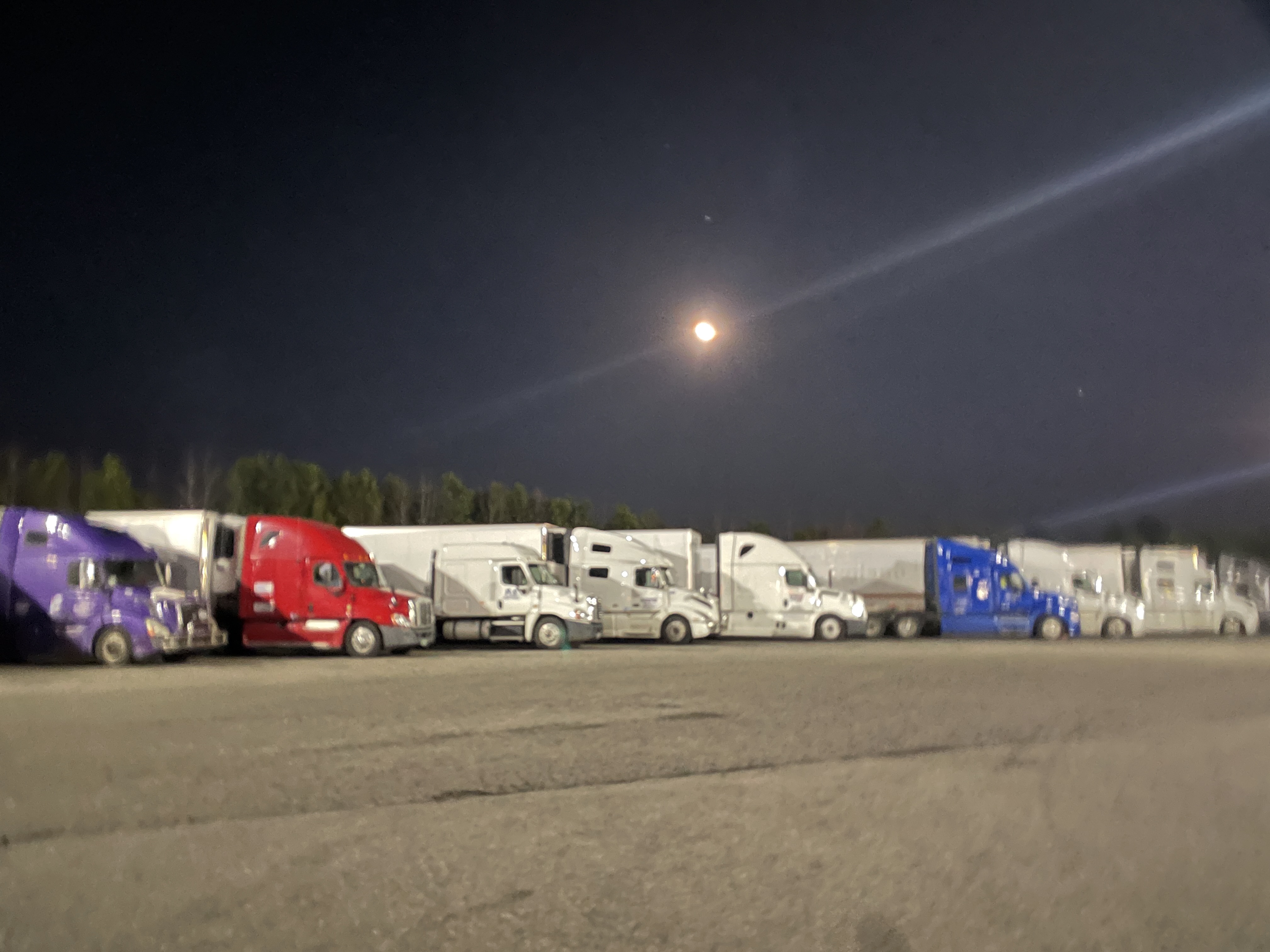 Group of truckers waiting in a truckstop parking lot