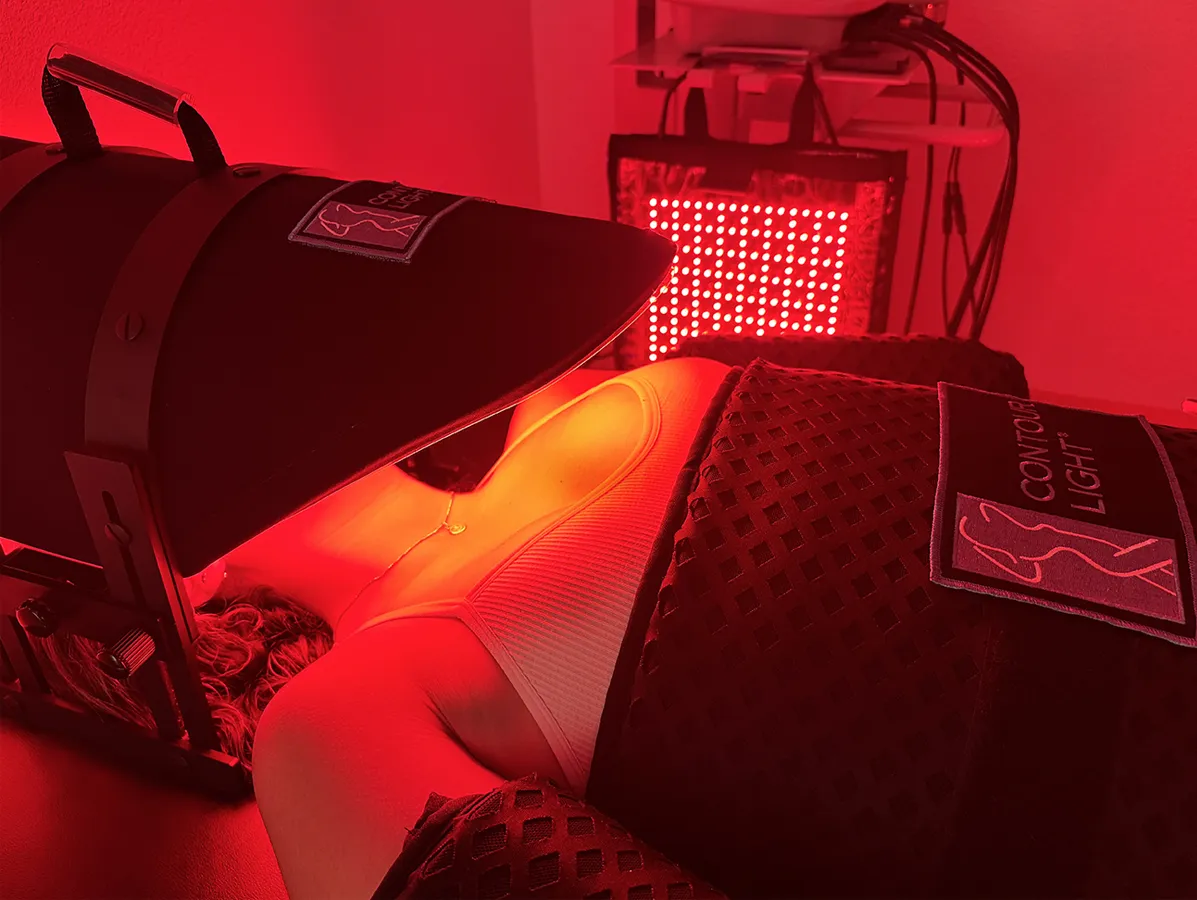 A client relaxing during a full body Red Light Therapy session for non-invasive fat loss and skin rejuvenation at our Cedar Park wellness center.