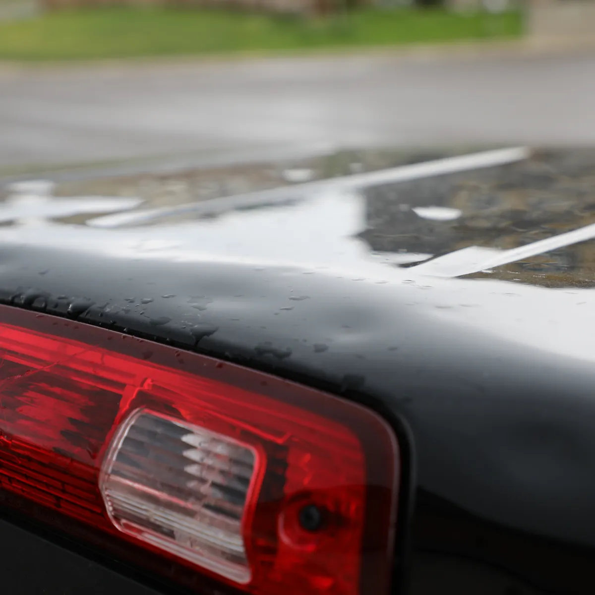 Small hail damage on back of black car
