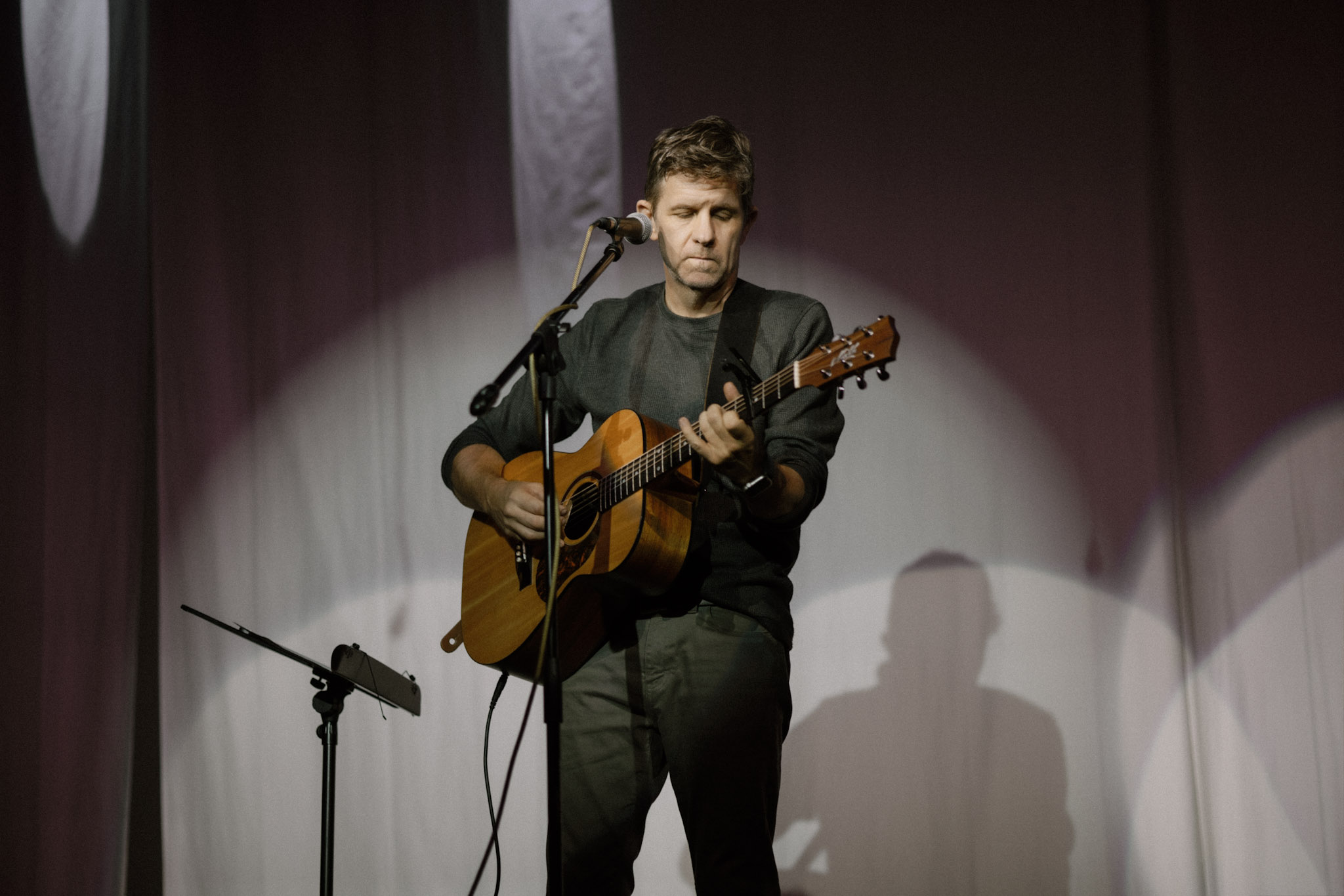 Ross King playing acoustic guitar