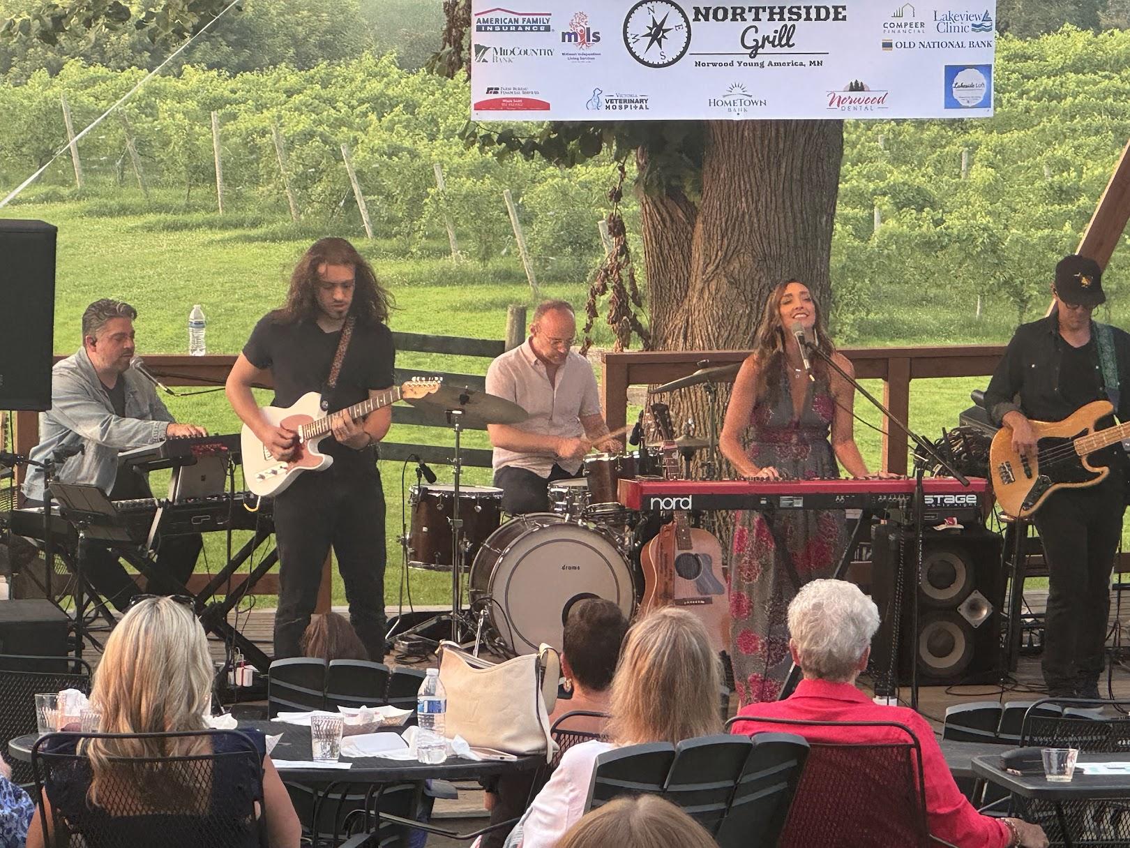 Jenn Bostic and her band are performing live at a music festival