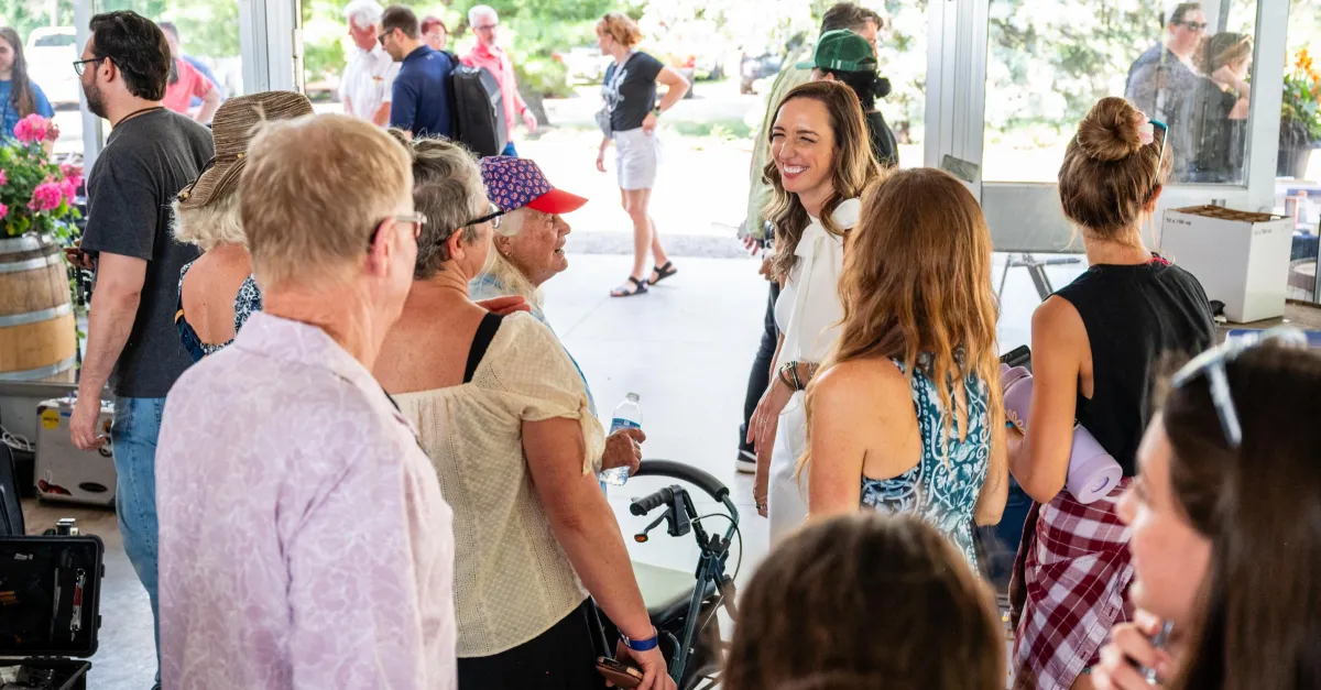 Jenn Bostic laughs with guests at a Meet & Greet before a church concert