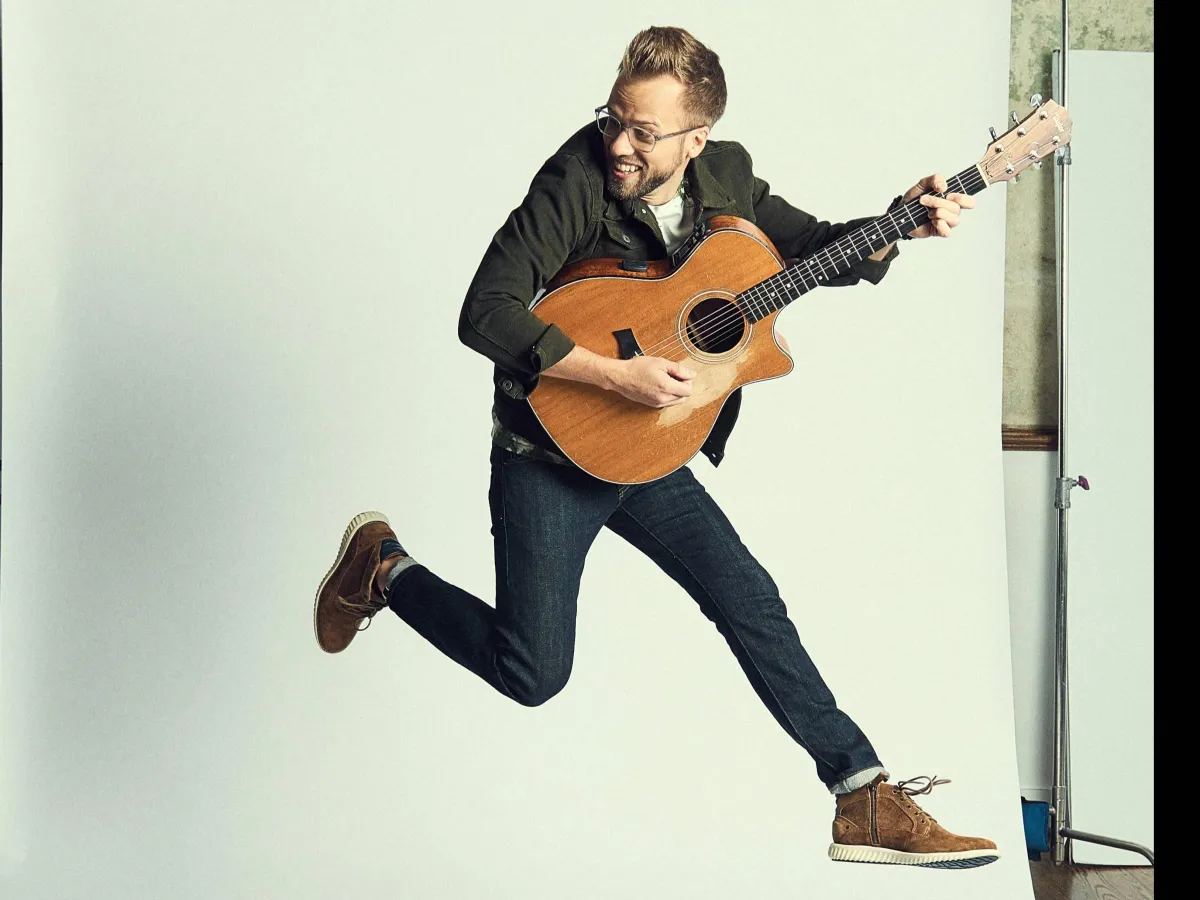 Josh Wilson jumping with guitar