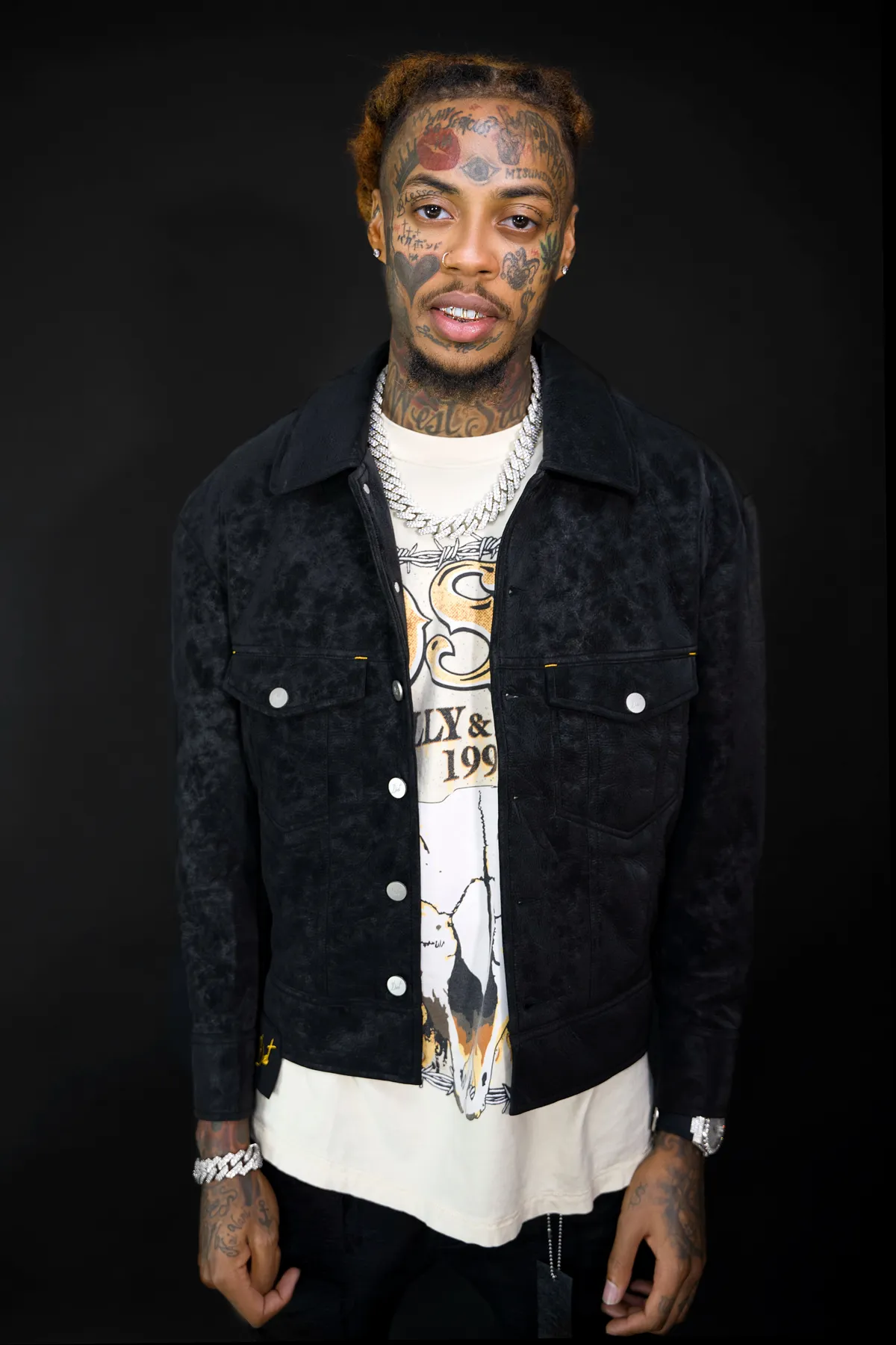 Christian Music Artist Demaree poses for  booking photo near window