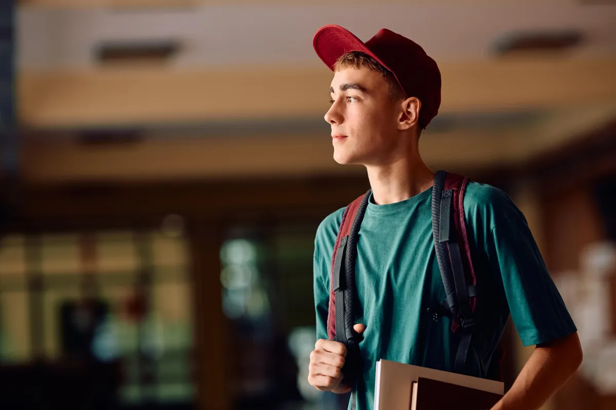 young white male student looking out a window