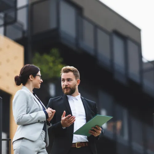 Two real estate professionals talking about a deal on a commercial property