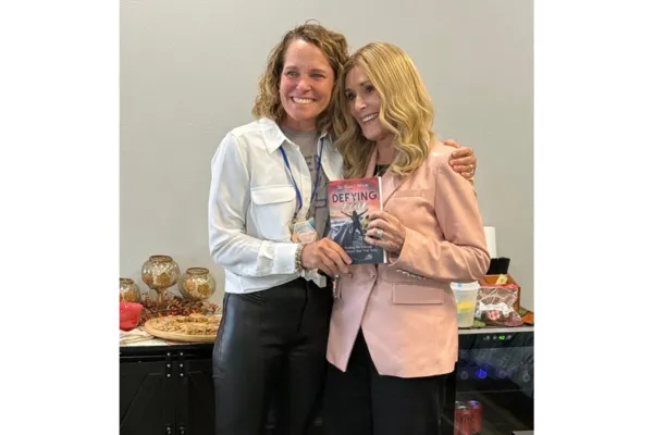 Dr. Nancy Meyer with Sheila Walsh holding Defying Fear at the Surrounded Women's Conference