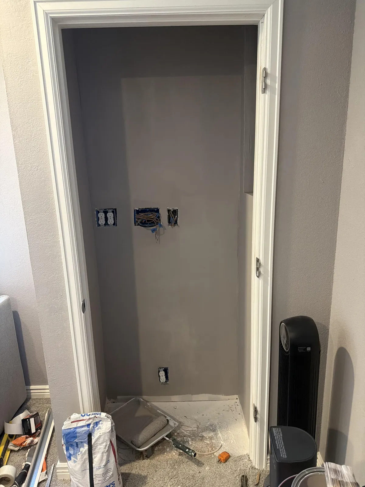 Wide view of a large dark wood bathroom vanity with dual sinks, mirrors, and sconce lighting.
