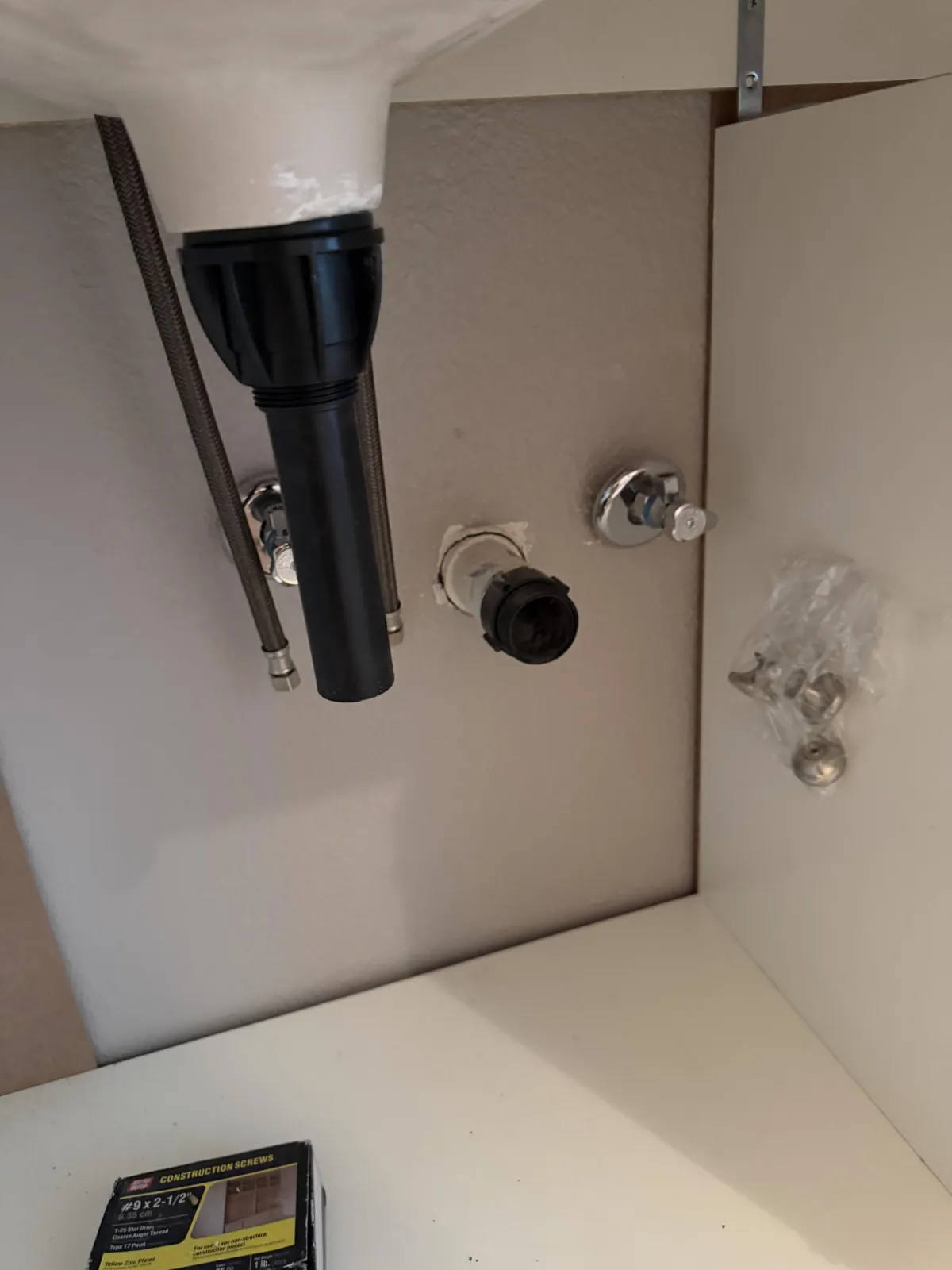 Modern bathroom interior showing a glass shower enclosure with black fixtures and a white vanity sink.