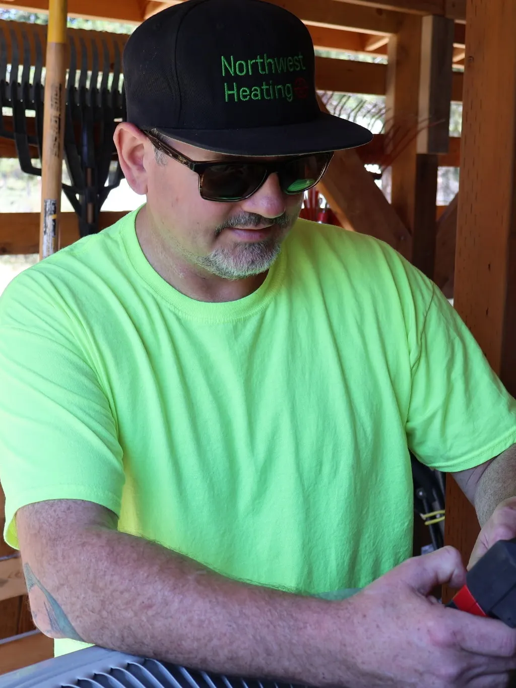 Northwest Heating LLC technician servicing an outdoor air conditioner in Central Oregon