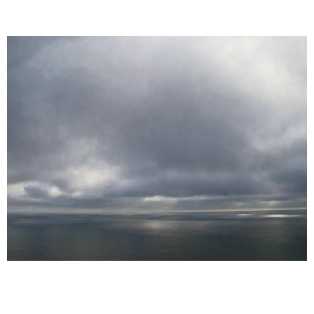 photograph of mottled sky on sea