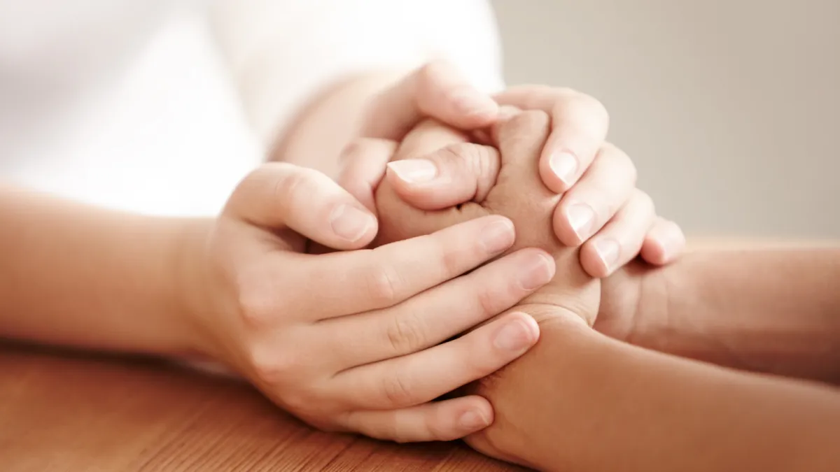 a close up of two people holding hands