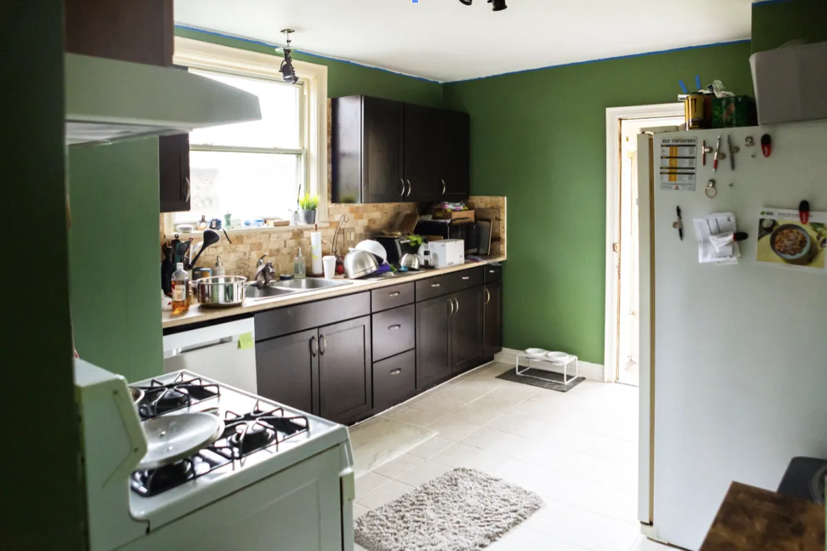 green kitchen with cluttered counters