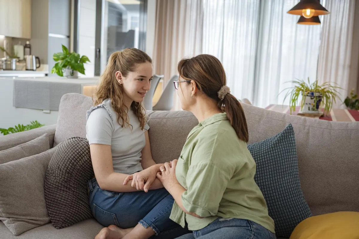 person holding white and black cat