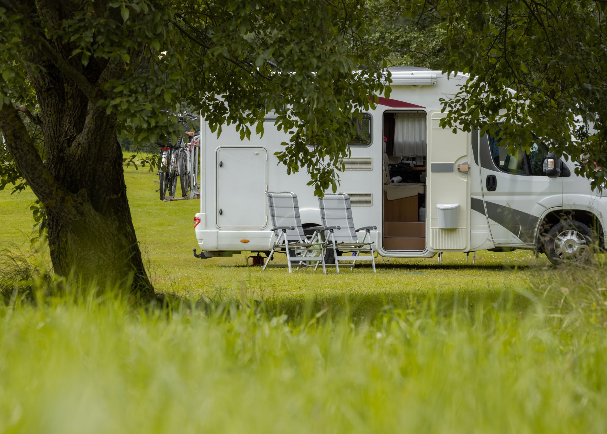 Photorealistic horsebox traveling on a UK country lane with hedgerows, sunlit/overcast mix, composed for a 3:2 landscape crop