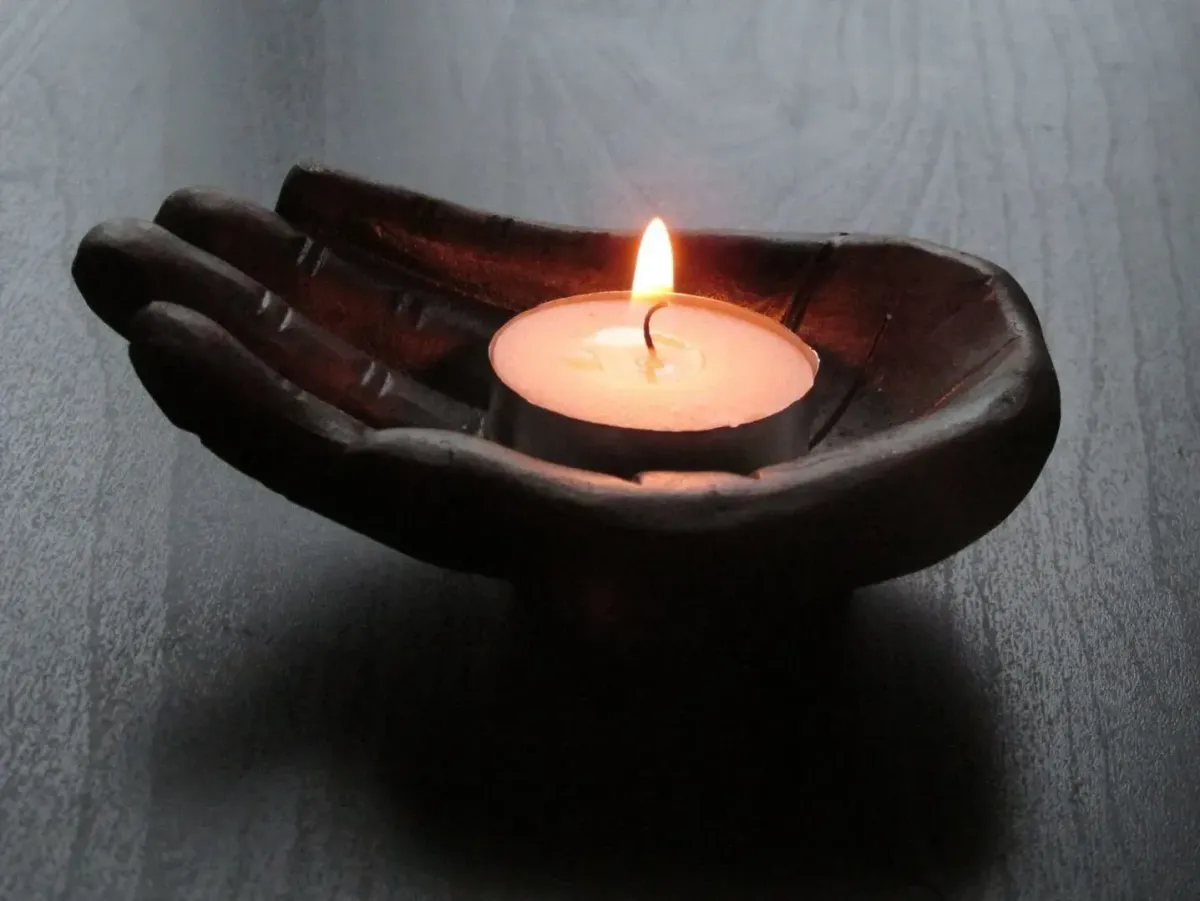 Hands holding candle