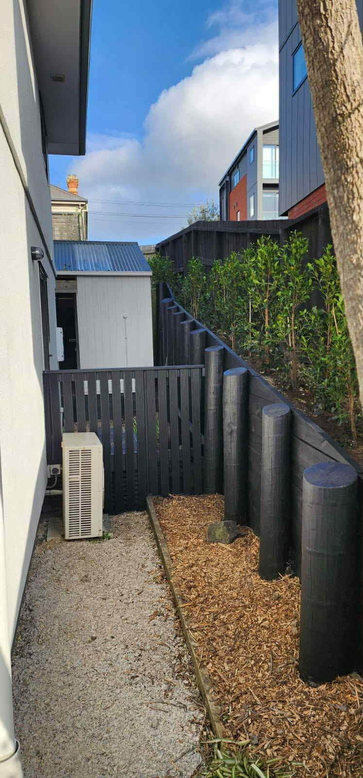 fence painting Auckland dark timber fence modern residential property Manukau